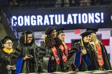 photo of graduates in caps and gowns, regalia