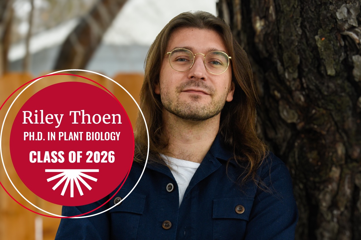 Riley Thoen in front of tree