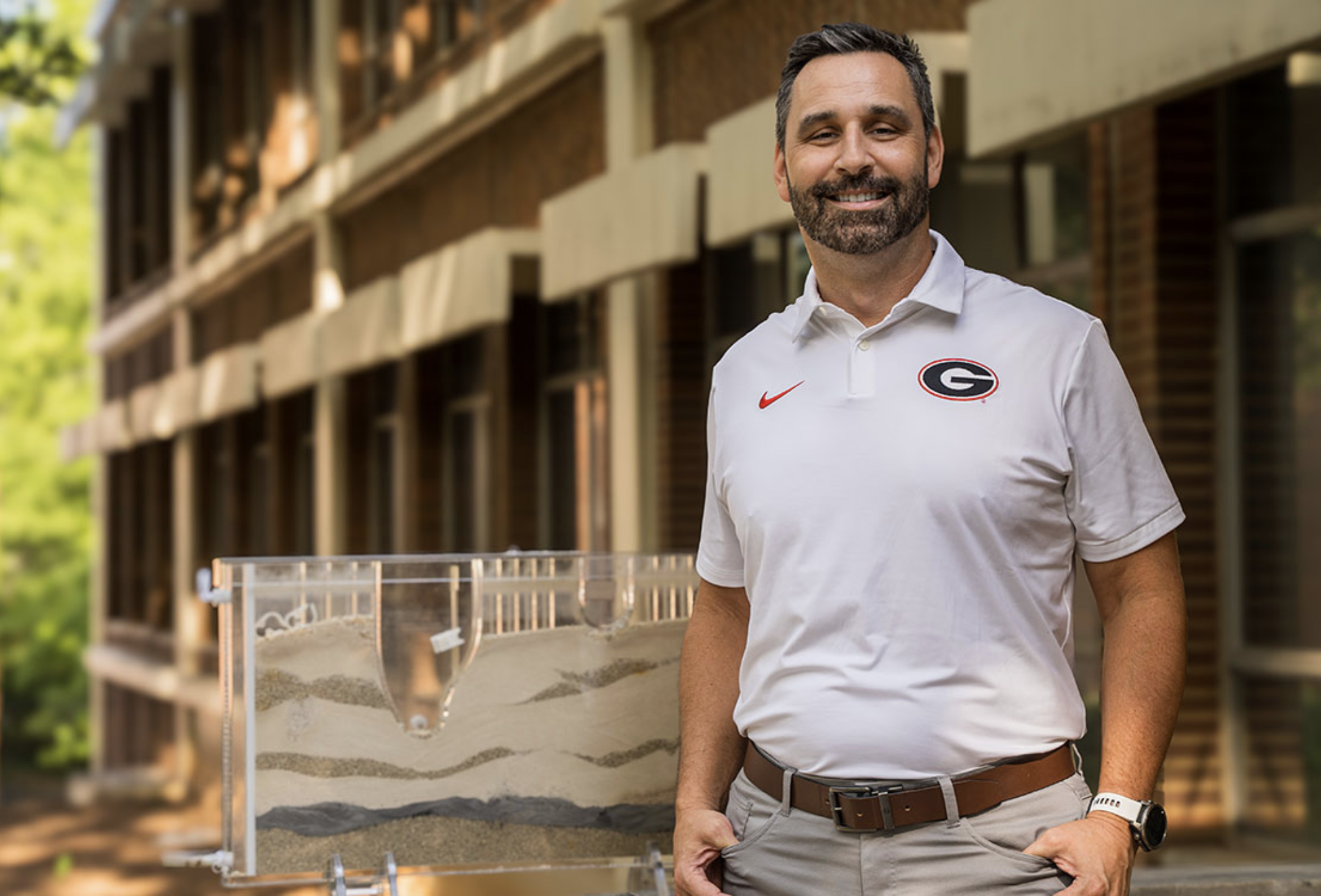 Adam stands in front of the geology building