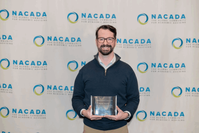 photo of man holding plaque