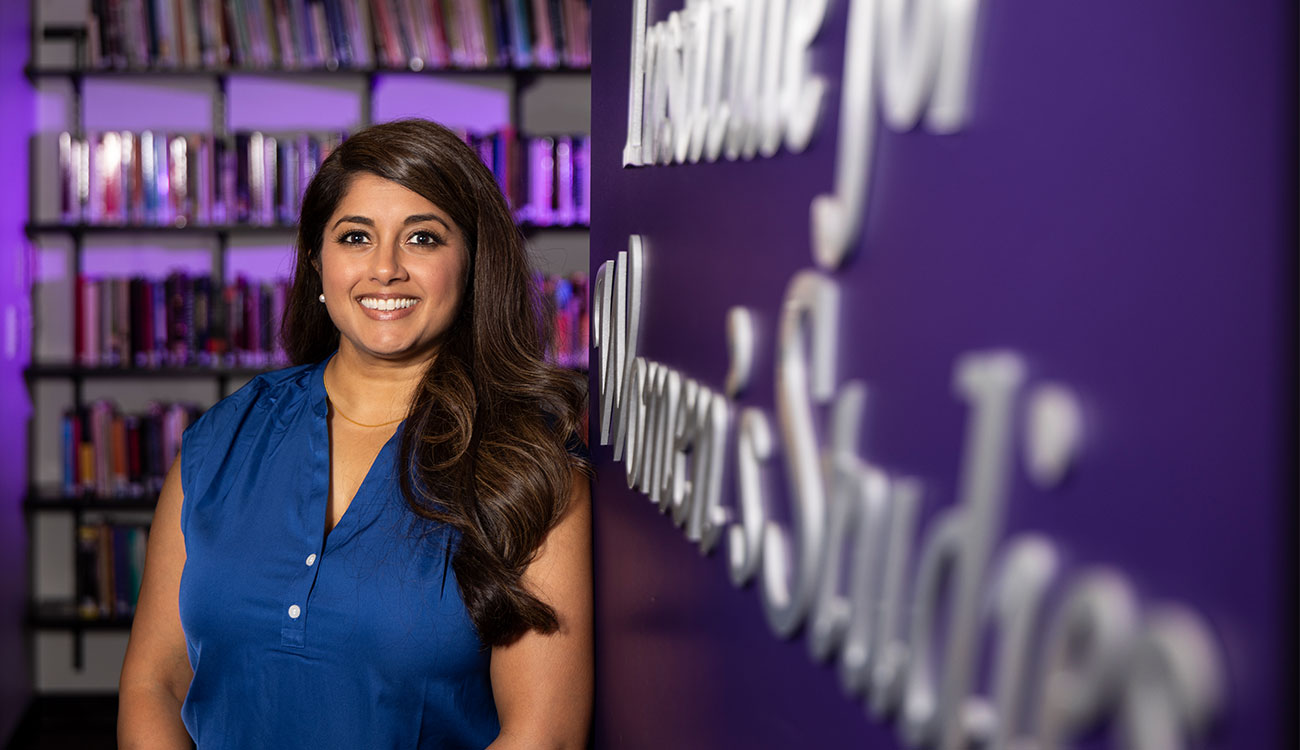 photo of woman and sign, books in background