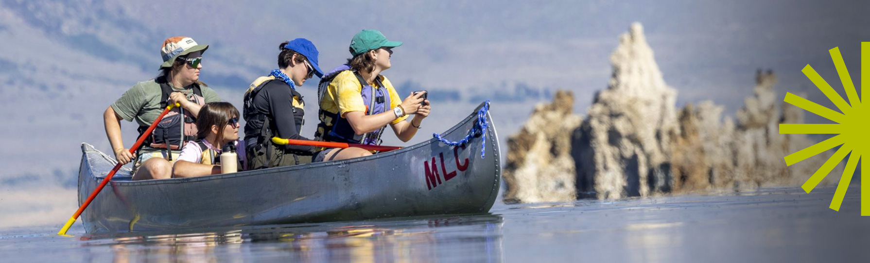 Four students rowing in a canoe 