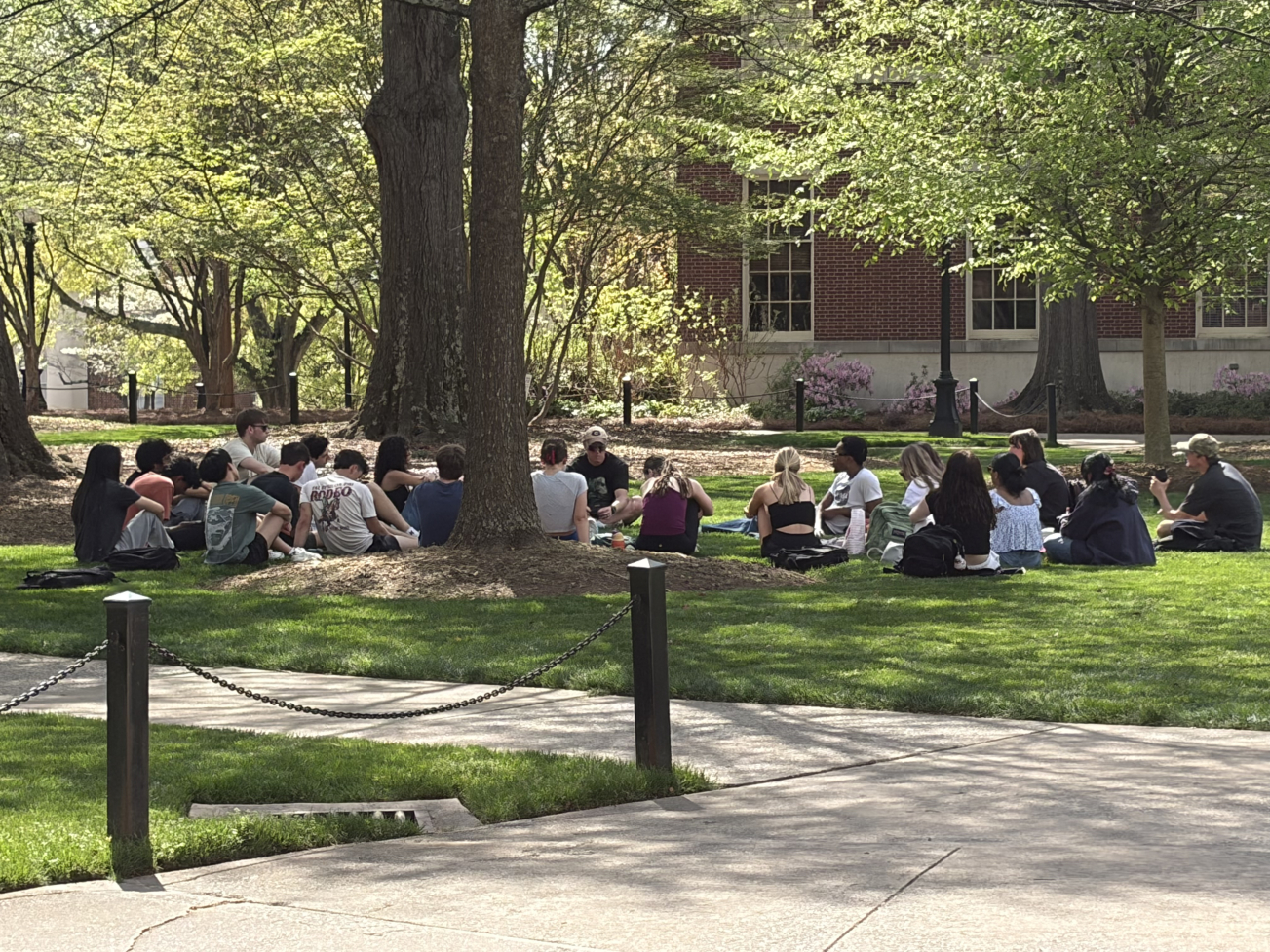 Alex Asay and students sitting on the lawn