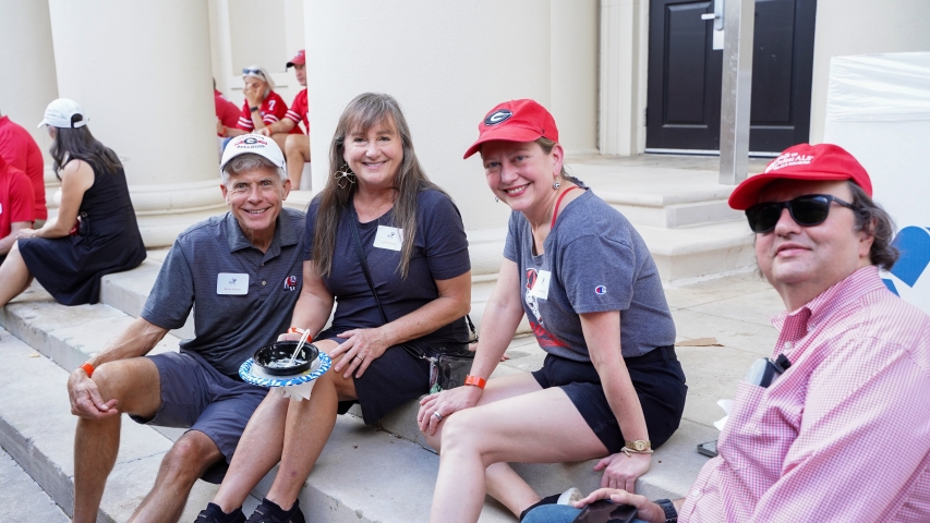 photo fo four people on steps