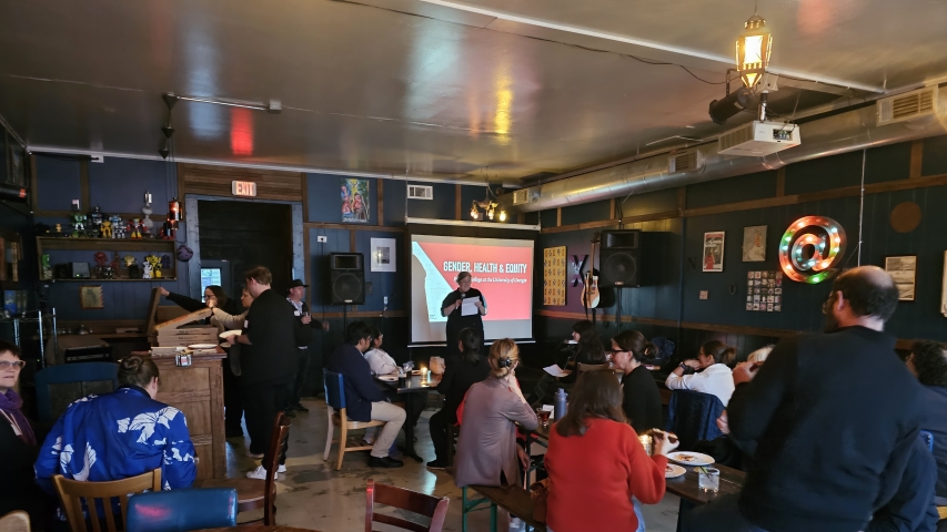 photo of speaker with audience