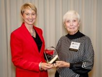 Photo of two women holding award
