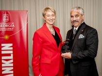 Photo of two people holding award