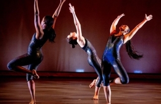 three women dancing on a stage