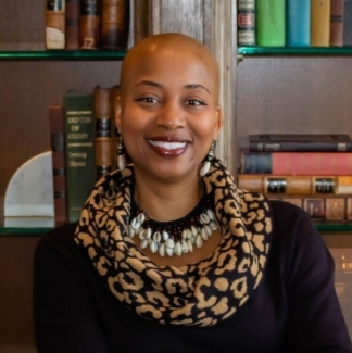 photo of woman, book shelves in background