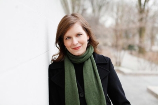 photo of woman outdoors, next to wall