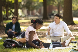 photo of three people on the quad lawn