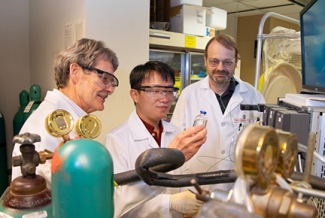 photo of three men in a lab