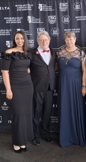 Photo of three people, with graphic backdrop