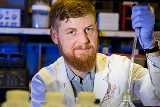 man in lab with syringe 