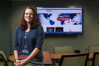 woman with flat screen TV in background, classroom