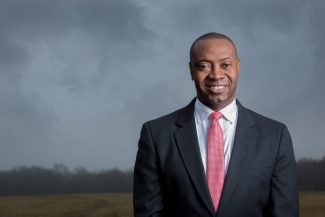 photo of man, outdoors, with stormy sky background