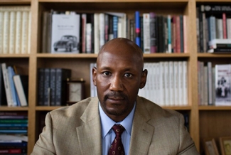 photo of man with bookshelves