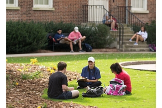 students on the lawn in front of old college