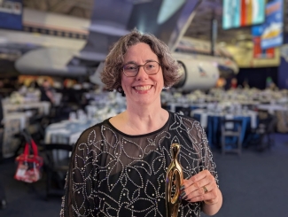 photo of woman with award trophy