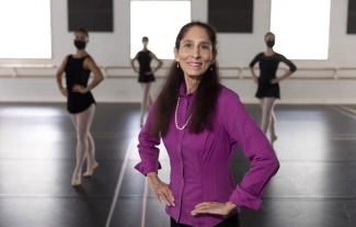 photo of woman in studio, with dancers in background