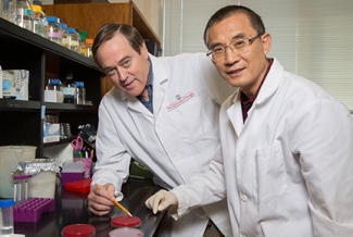 two men in a lab with white coats