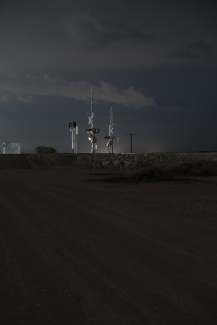 photo of a railroad crossing at night