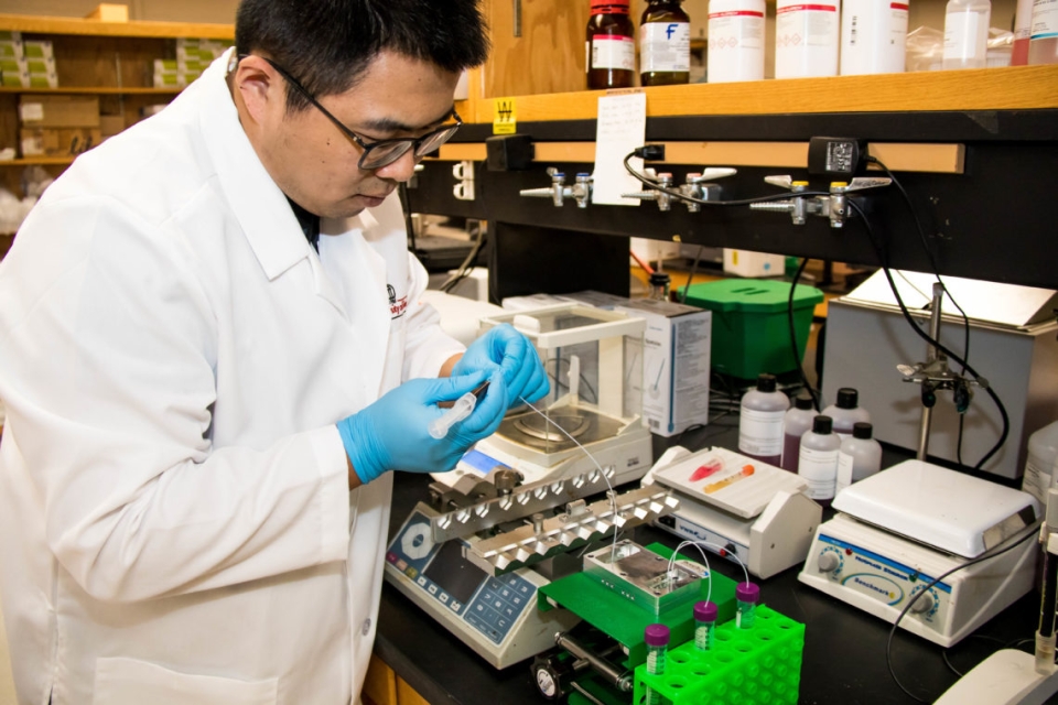 Yang Liu sets up the device for an experiment.