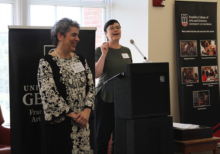 Lisa Donovan, department head of plant biology (right) presents a Staff Excellence in service award to Gretchen Bowen