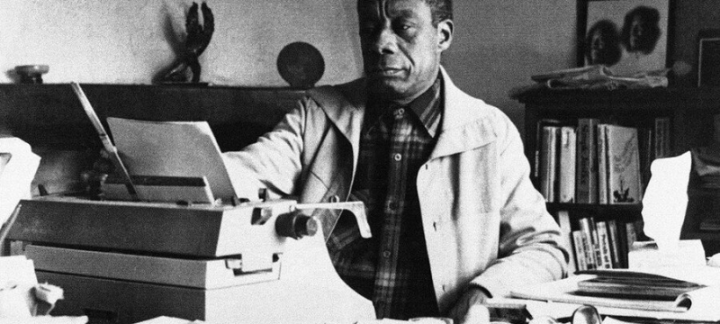 b/w photo of man with typewriter