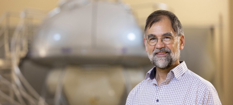 photo of man with lab equipment in background