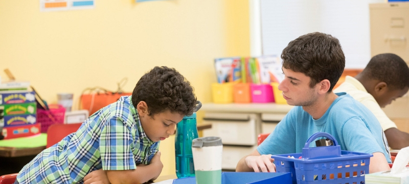 photo o f student with school children, classroom
