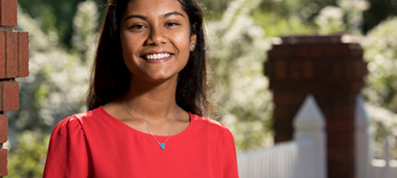 photo of woman at garden fence