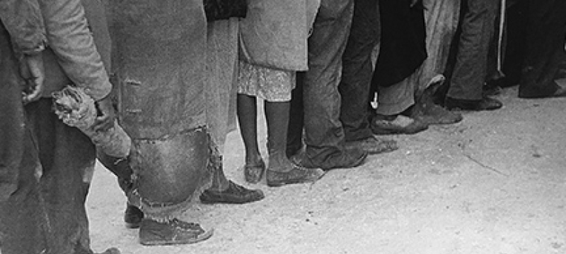 black and white photo of people standing in line