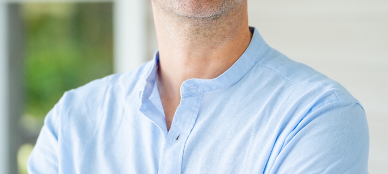 photo of man, house in background, day