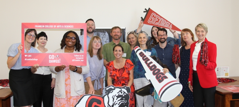 group photo of people holding banners with brnding