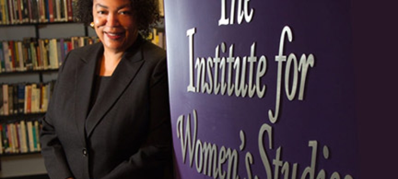 photo of woman with wall and books