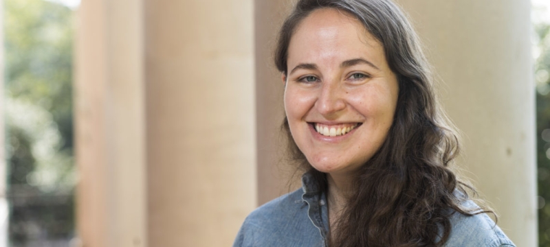 photo of a woman in front of a column