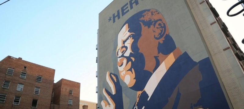 photo of a mural of man painted on side of a building