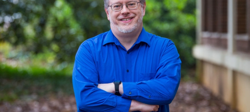 photo of man in blue shirt, outdoors
