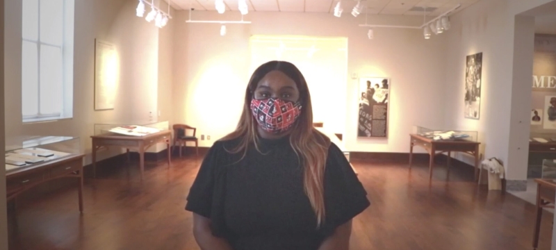 photo of woman with tables and light in background 