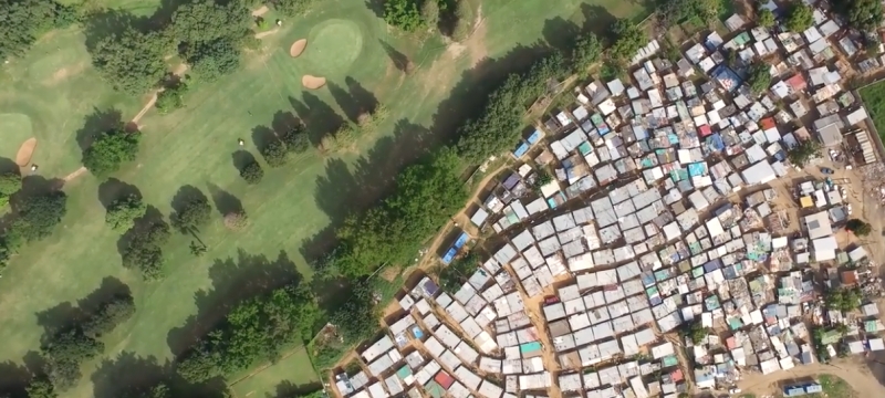 aerial photo of golf course contiguous to dense housing