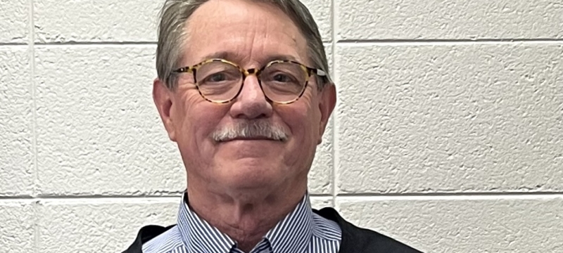 photo of man holding a crystal model