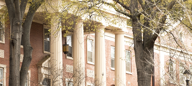 photo of building portico, with spring blooms