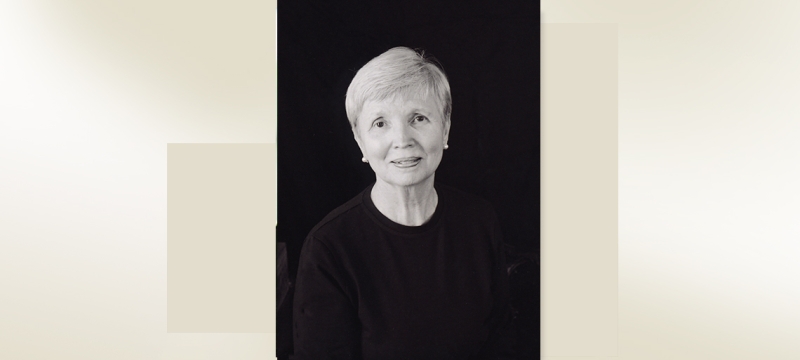headshot of woman on black back ground with color block