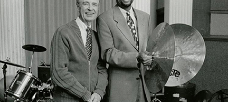 black and white photo of two men, with drums and cymbals