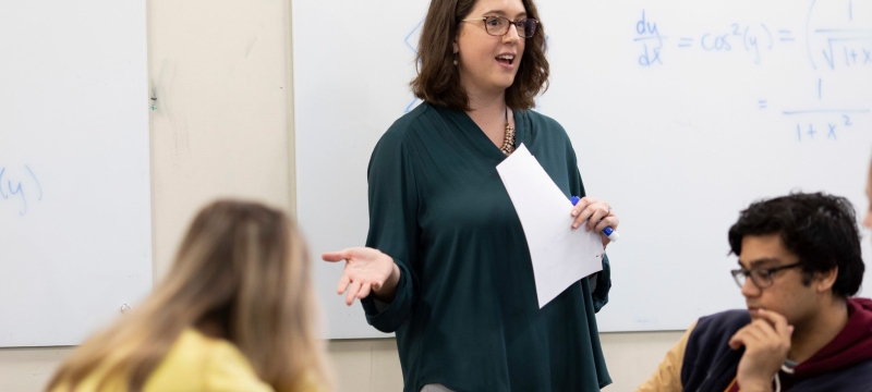 photo of woman speaking to students in classroom