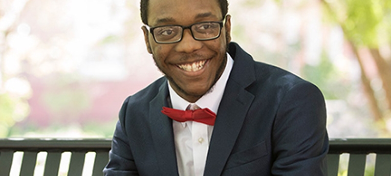 man in suit, seated, outside