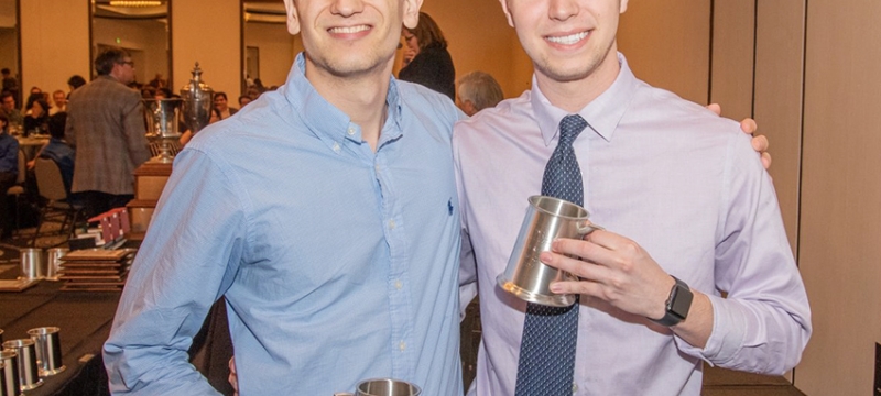 Photo of two men holding silver steins