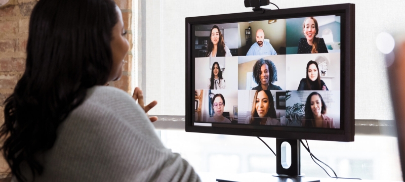 photo of woman looking at computer screen with faces