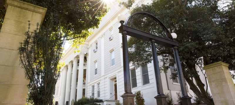 photo of arch, building in background, day